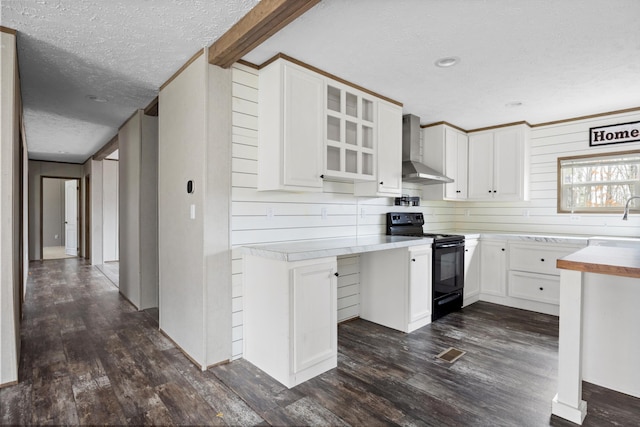 kitchen featuring white cabinetry, dark wood-type flooring, wall chimney range hood, black electric range oven, and a textured ceiling