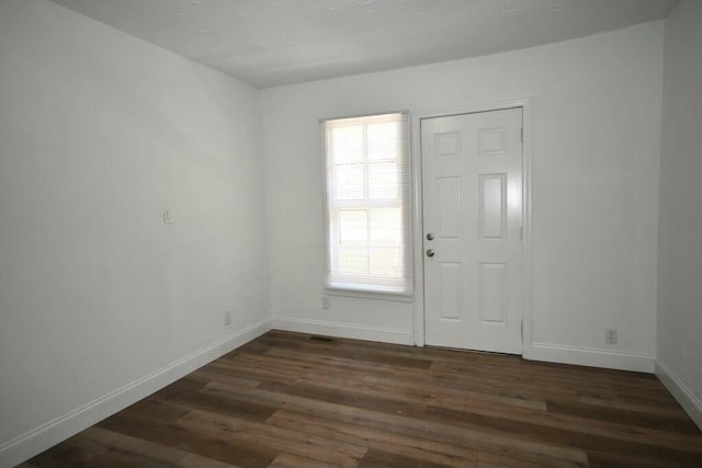 entryway with dark wood-type flooring