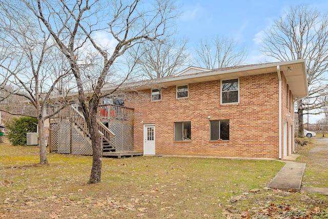 rear view of property with a lawn and a deck