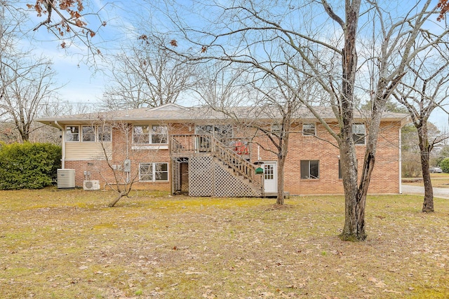 back of house with a yard and central AC unit