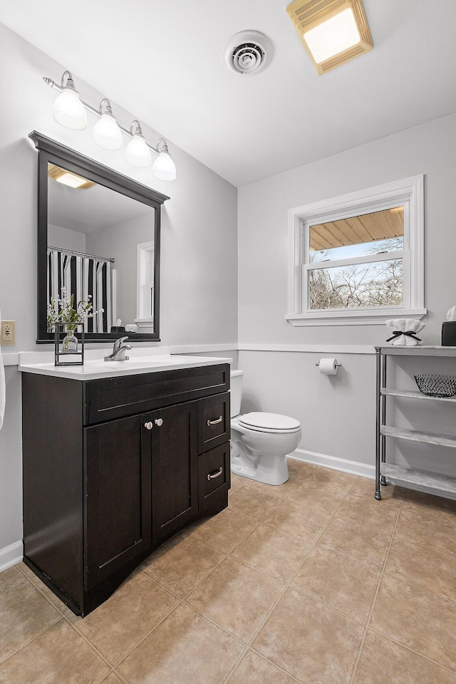 bathroom featuring tile patterned floors, vanity, and toilet