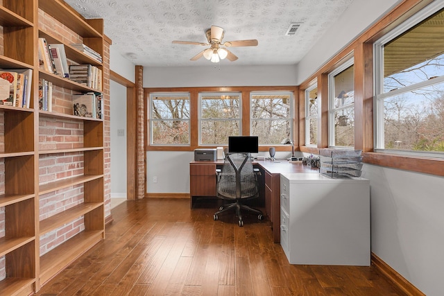 office space with ceiling fan, a textured ceiling, and dark wood-type flooring