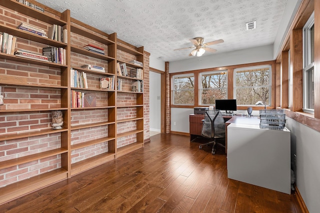 office space featuring ceiling fan, dark hardwood / wood-style flooring, and a textured ceiling