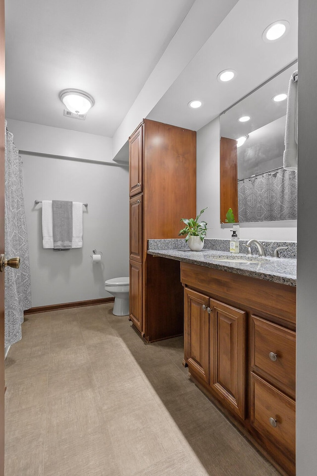 bathroom featuring vanity and toilet