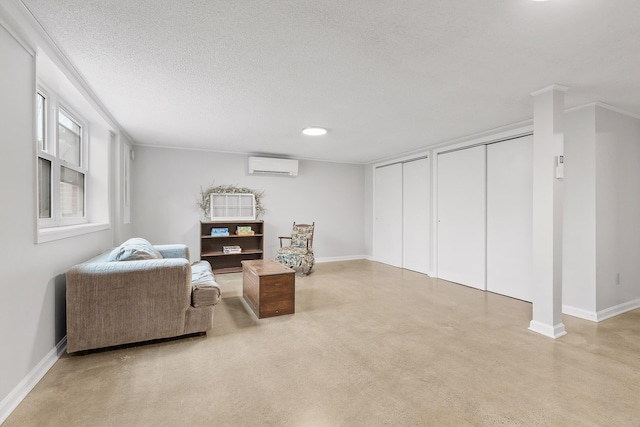 sitting room featuring an AC wall unit, crown molding, and a textured ceiling