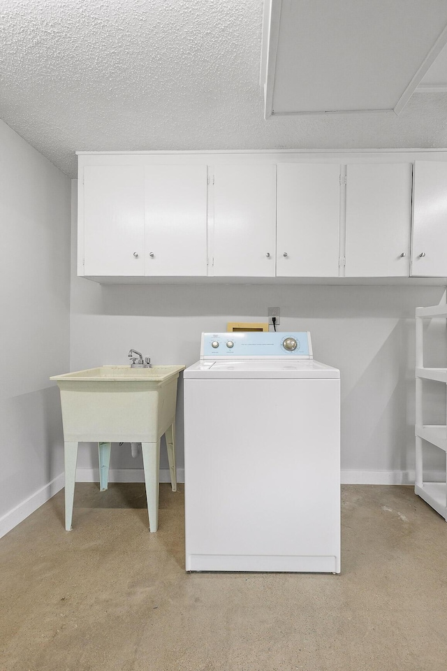 washroom with cabinets, washer / dryer, a textured ceiling, and light colored carpet