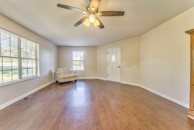 unfurnished room featuring ceiling fan and dark hardwood / wood-style floors