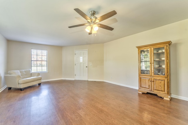 unfurnished room featuring dark hardwood / wood-style flooring and ceiling fan