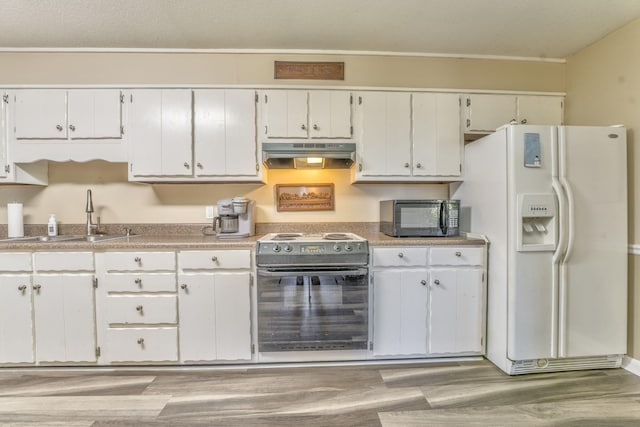 kitchen featuring sink, white cabinets, black appliances, and light hardwood / wood-style floors