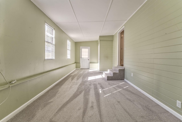 carpeted spare room featuring lofted ceiling