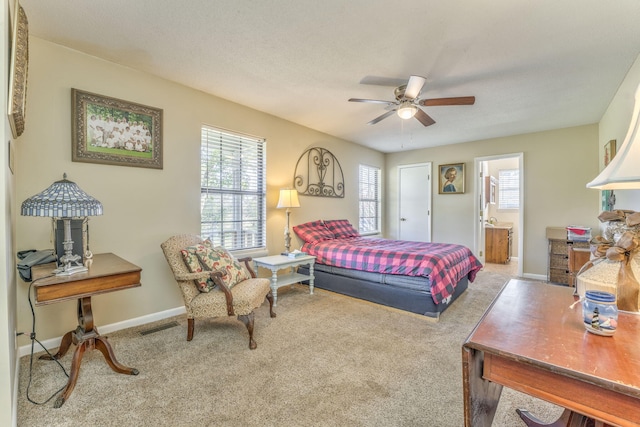 bedroom featuring carpet flooring, ensuite bathroom, and ceiling fan