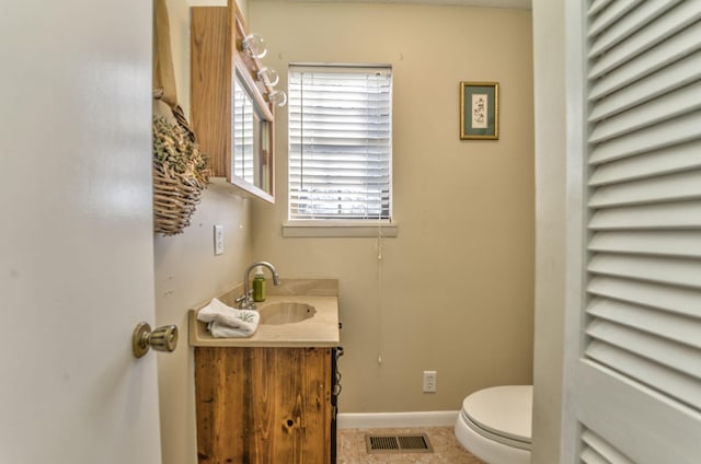 bathroom with tile patterned floors, vanity, and toilet