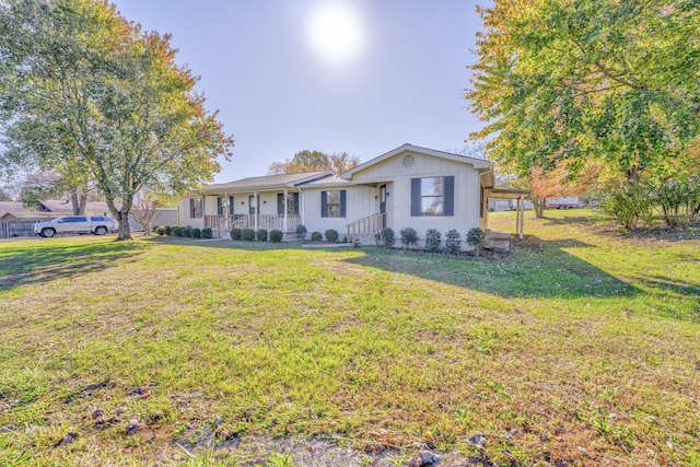 single story home with covered porch and a front yard