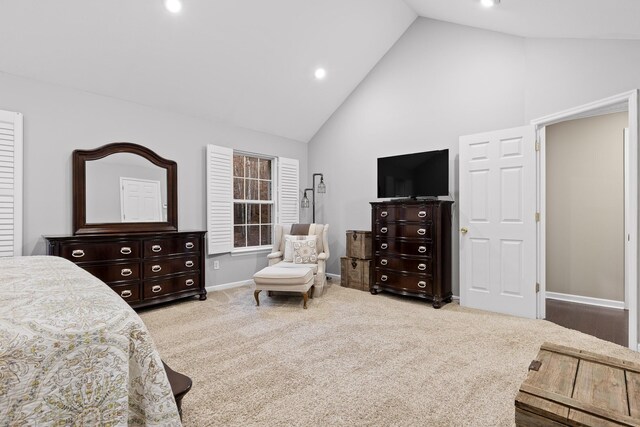 bedroom with light carpet and high vaulted ceiling