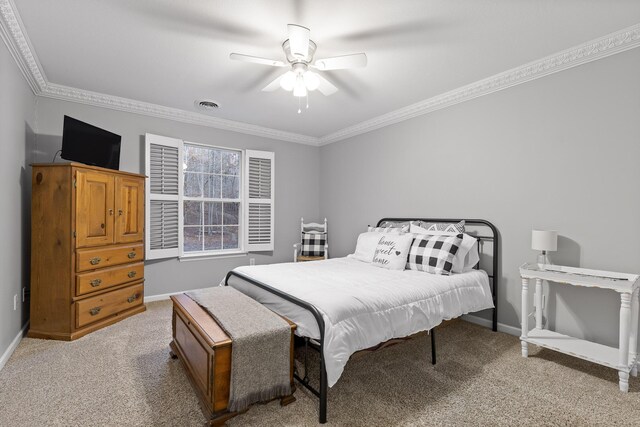 carpeted bedroom featuring crown molding and ceiling fan