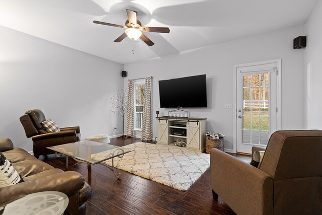 living room with ceiling fan and dark hardwood / wood-style flooring