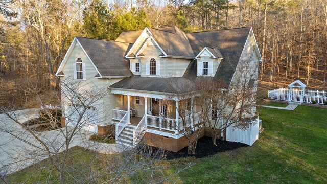 view of front of home featuring covered porch and a front lawn