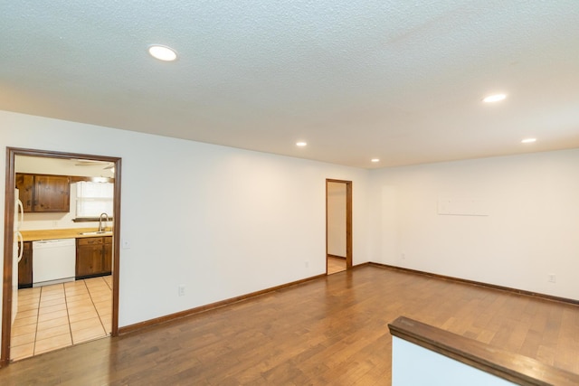 unfurnished room with light hardwood / wood-style flooring and sink