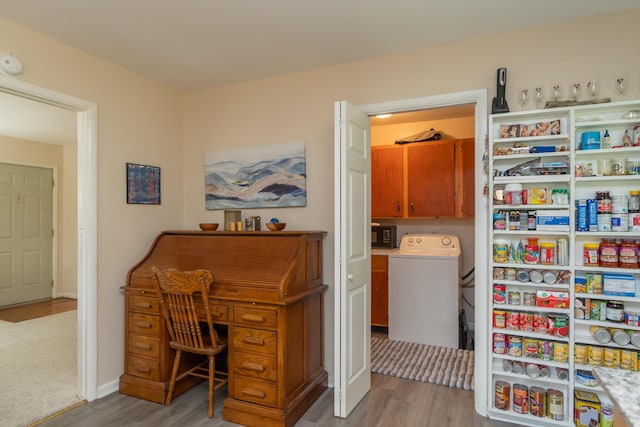 interior space with light hardwood / wood-style flooring, cabinets, and washer / dryer