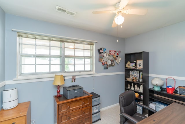 carpeted office space featuring ceiling fan and a healthy amount of sunlight