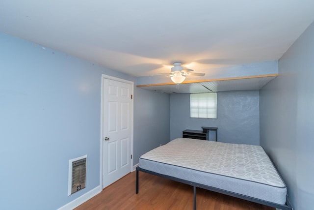 bedroom with hardwood / wood-style floors and ceiling fan