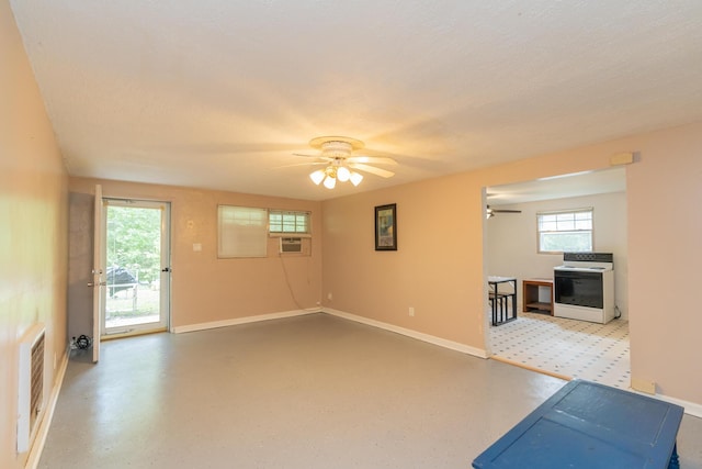 interior space featuring a textured ceiling, cooling unit, and ceiling fan