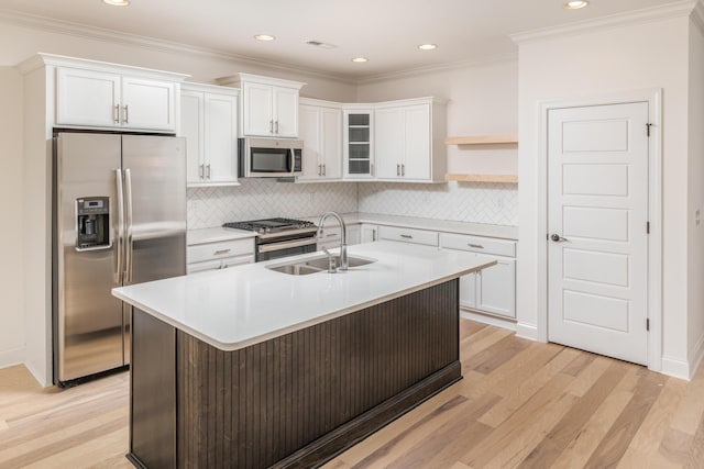 kitchen with light wood-type flooring, white cabinetry, sink, and appliances with stainless steel finishes