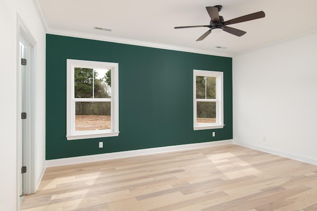 unfurnished room featuring plenty of natural light, ceiling fan, light wood-type flooring, and crown molding