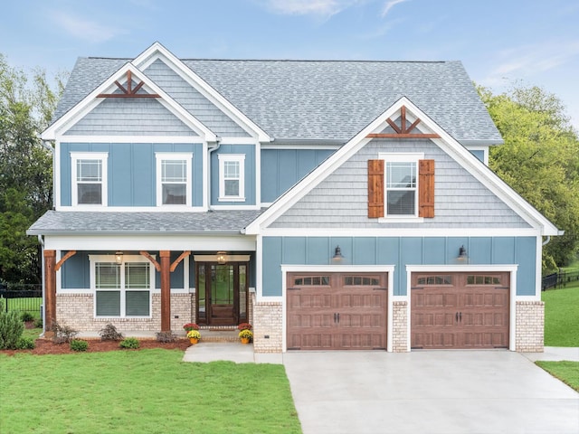 craftsman-style home featuring a garage and a front lawn