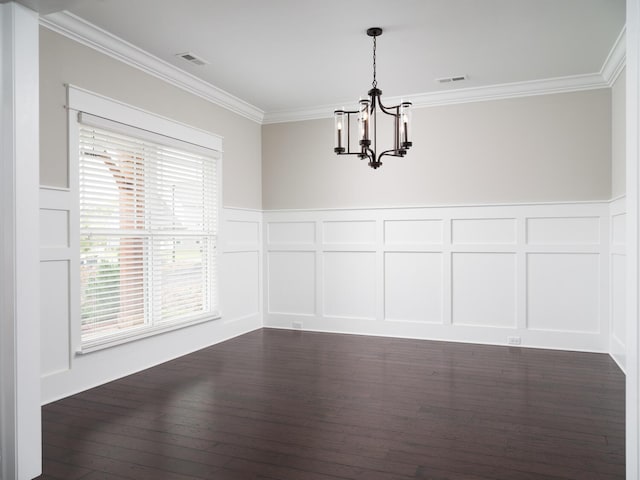 unfurnished dining area featuring ornamental molding, dark wood-type flooring, and a notable chandelier