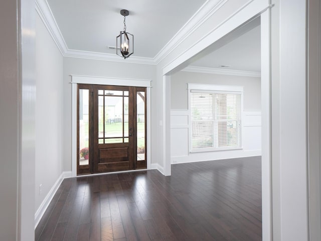 foyer with a healthy amount of sunlight, crown molding, and dark wood-type flooring