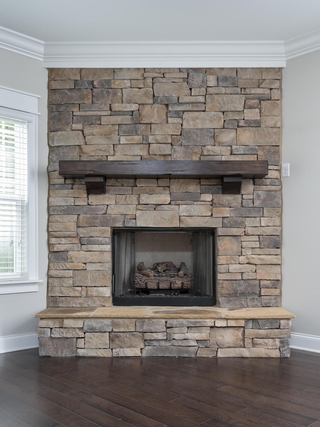 details featuring a stone fireplace, hardwood / wood-style floors, and ornamental molding