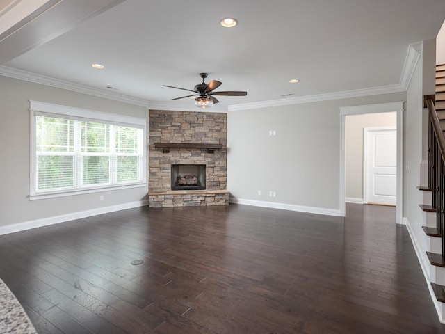 unfurnished living room featuring dark hardwood / wood-style floors, ornamental molding, and a fireplace