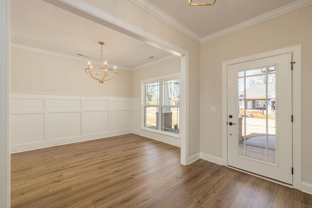 9089 Knolling Loop Unit 87, Ooltewah, TN 37363 - foyer with a chandelier, wood finished floors, crown molding, a decorative wall, and wainscoting