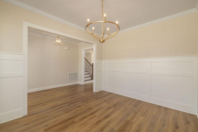 9089 Knolling Loop Unit 87, Ooltewah, TN 37363 - unfurnished room with a chandelier, wood finished floors, crown molding, stairs, and a decorative wall