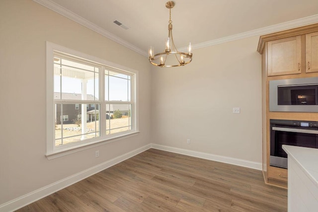9089 Knolling Loop Unit 87, Ooltewah, TN 37363 - unfurnished dining area with a chandelier, ornamental molding, light wood finished floors, and baseboards