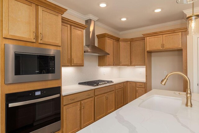 9089 Knolling Loop Unit 87, Ooltewah, TN 37363 - kitchen featuring stainless steel appliances, wall chimney range hood, a sink, light stone counters, and decorative light fixtures