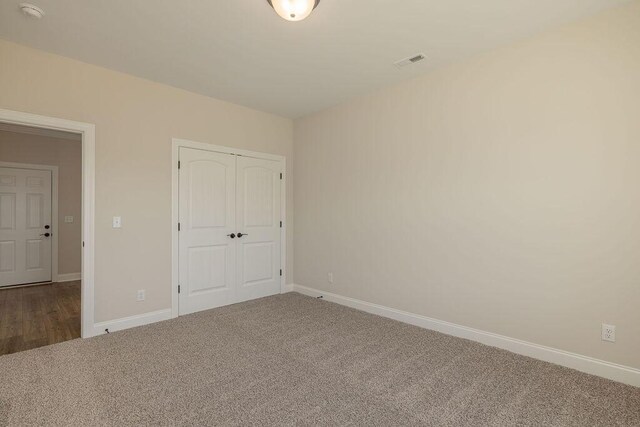 9089 Knolling Loop Unit 87, Ooltewah, TN 37363 - unfurnished bedroom featuring carpet flooring, baseboards, and a closet