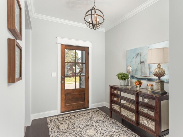 foyer entrance featuring wood-type flooring, crown molding, and an inviting chandelier