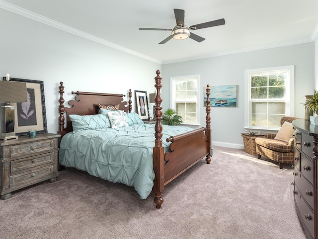 carpeted bedroom featuring multiple windows, crown molding, and ceiling fan