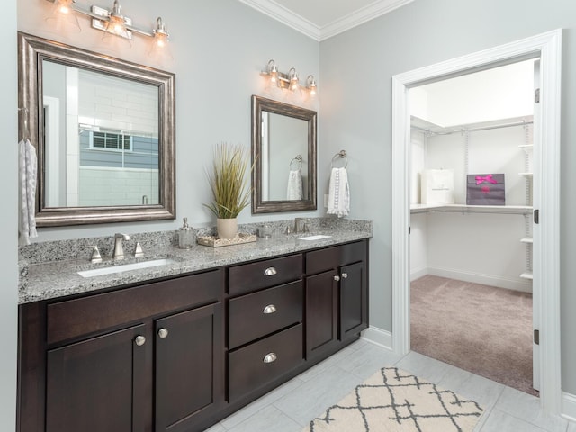 bathroom with tile patterned floors, crown molding, and vanity