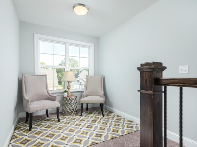 sitting room featuring light carpet and vaulted ceiling