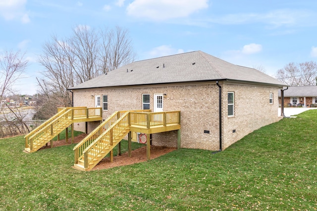 back of property with a yard and a wooden deck