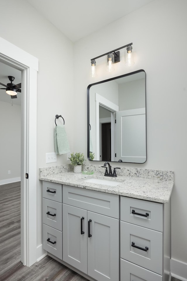 bathroom featuring hardwood / wood-style floors, ceiling fan, and vanity