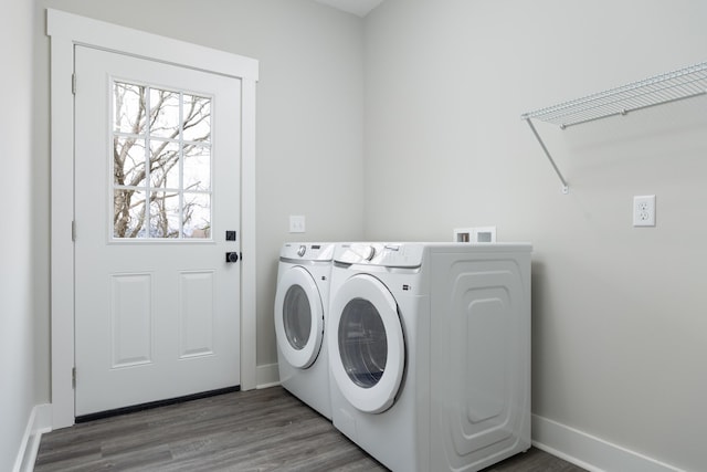 clothes washing area featuring washer and clothes dryer and hardwood / wood-style flooring