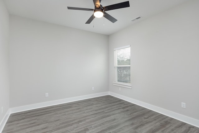 unfurnished room featuring ceiling fan and dark wood-type flooring