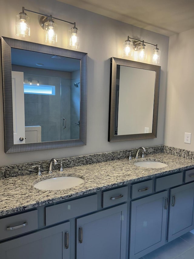 bathroom featuring vanity, tile patterned floors, and a shower with shower door