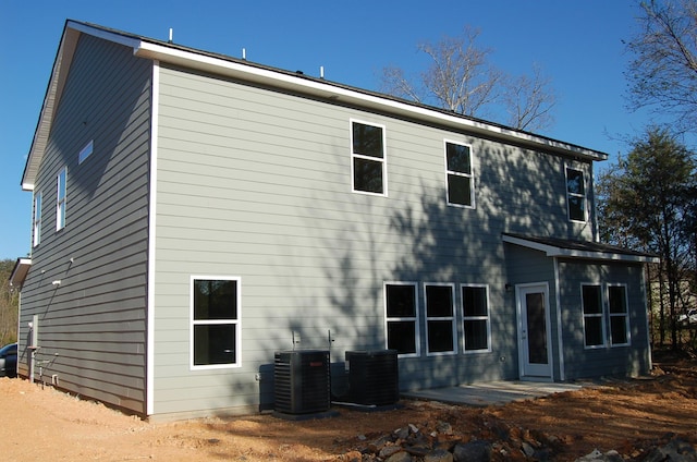 rear view of house with central air condition unit