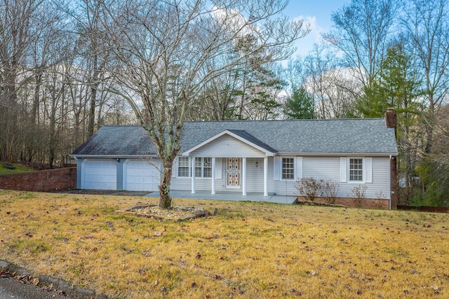 single story home featuring covered porch, a garage, and a front lawn