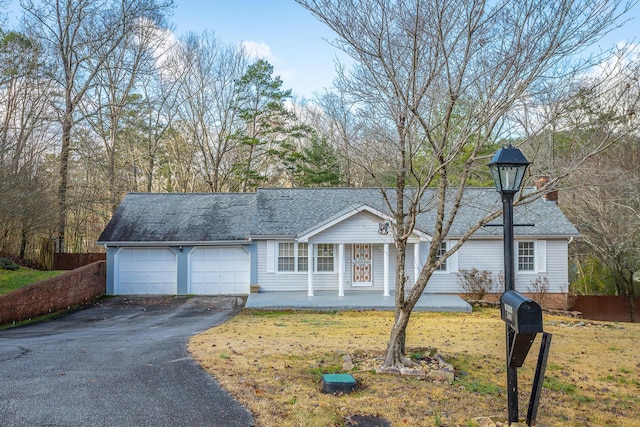 view of front of home with a front yard and a garage